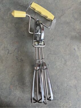 vintage Maynard hand crank egg beater with a yellow handle